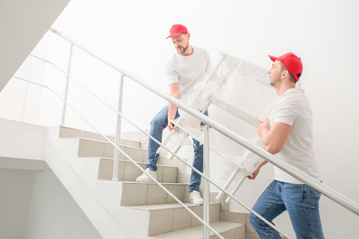 workers carrying furniture upstairs moving heavy items