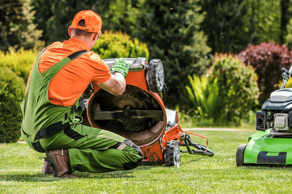 cleaning grass from lawn mower deck
