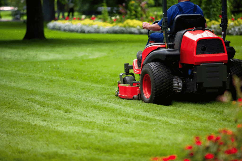 man mowing green lawn in Canadian suburb